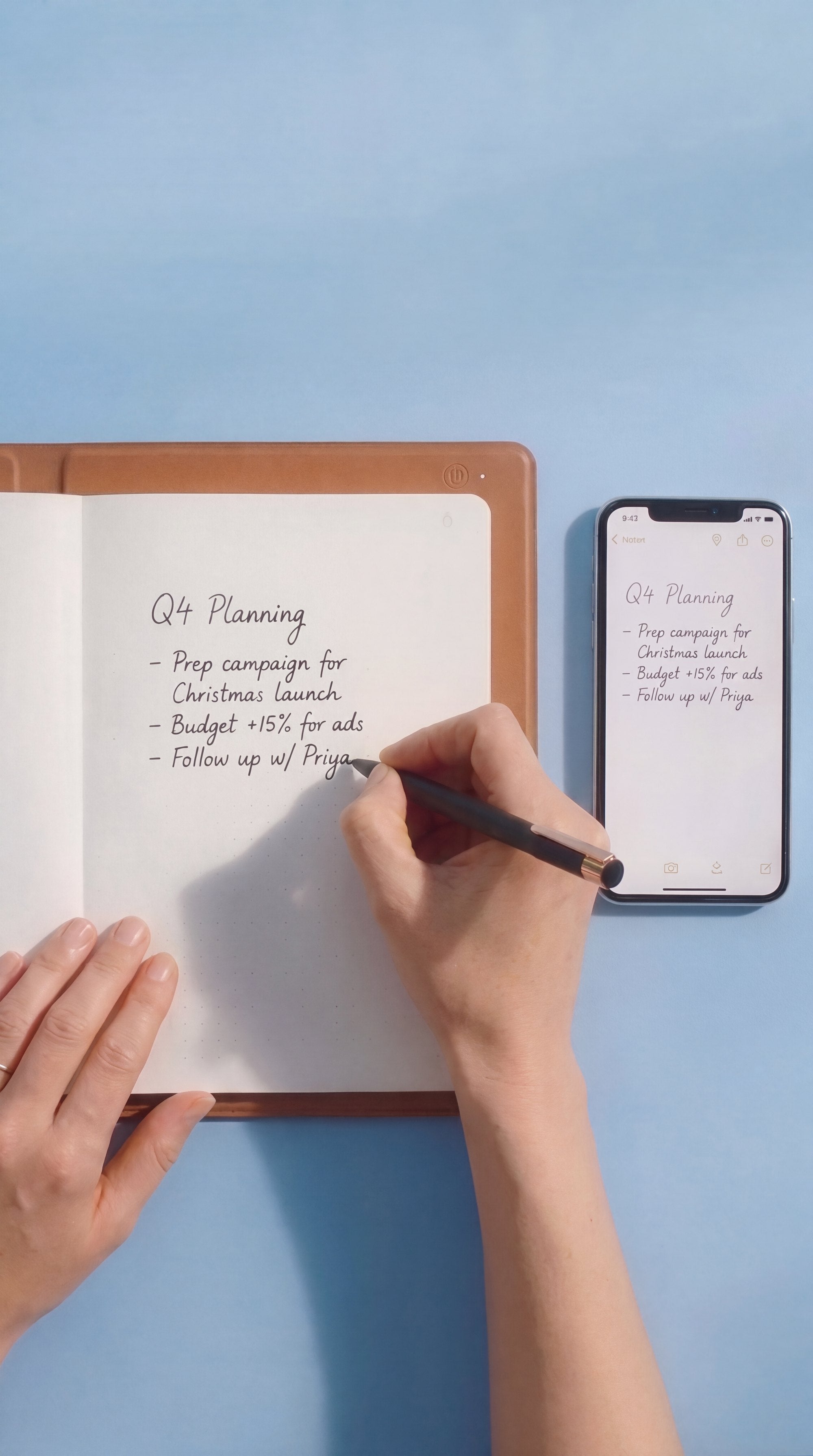 Top-down view of handwritten Q4 planning notes in NoteFlow, with the same notes synced on a phone beside it