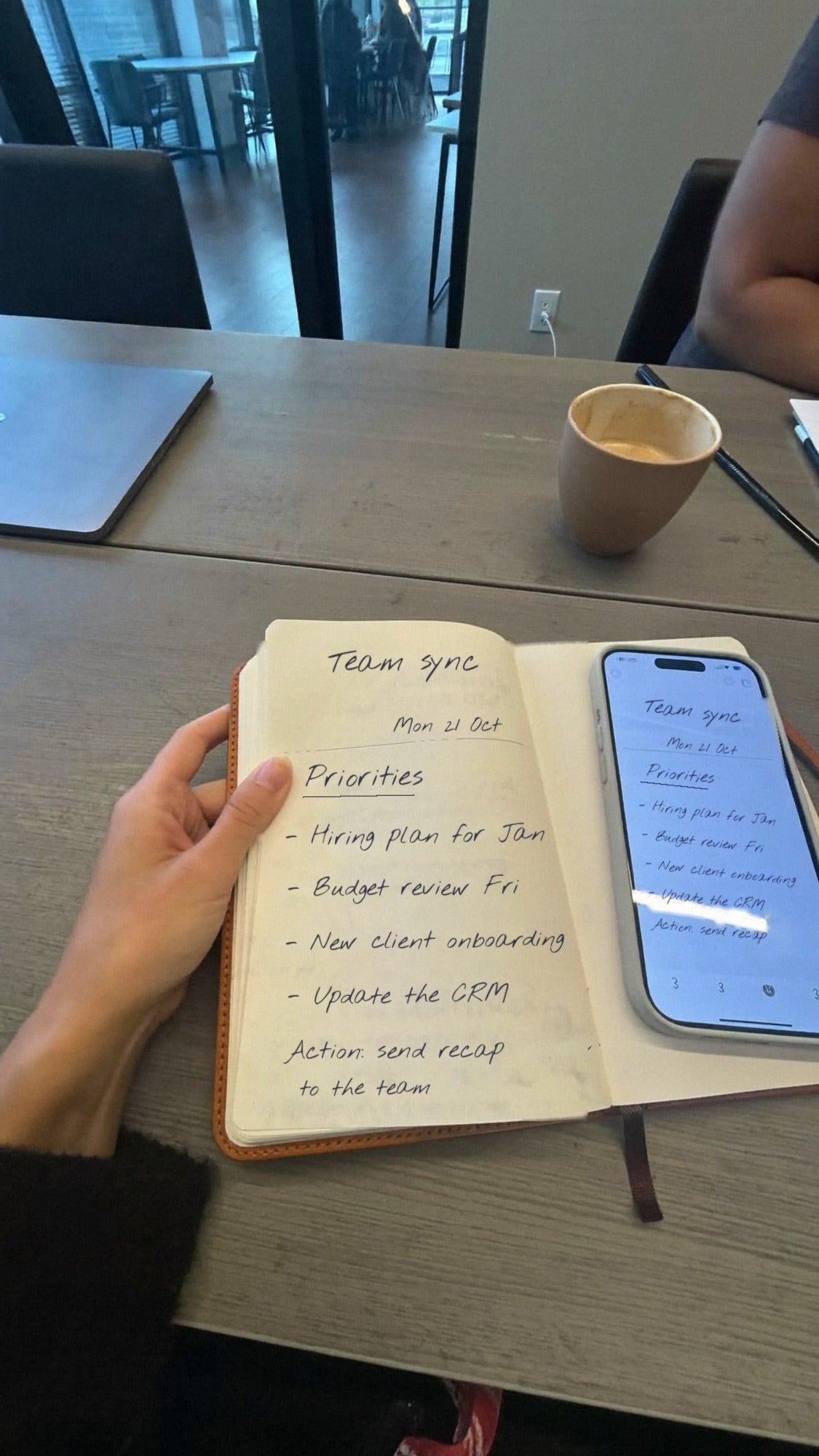NoteFlow open in a team meeting, with the same handwritten notes synced on a phone beside it